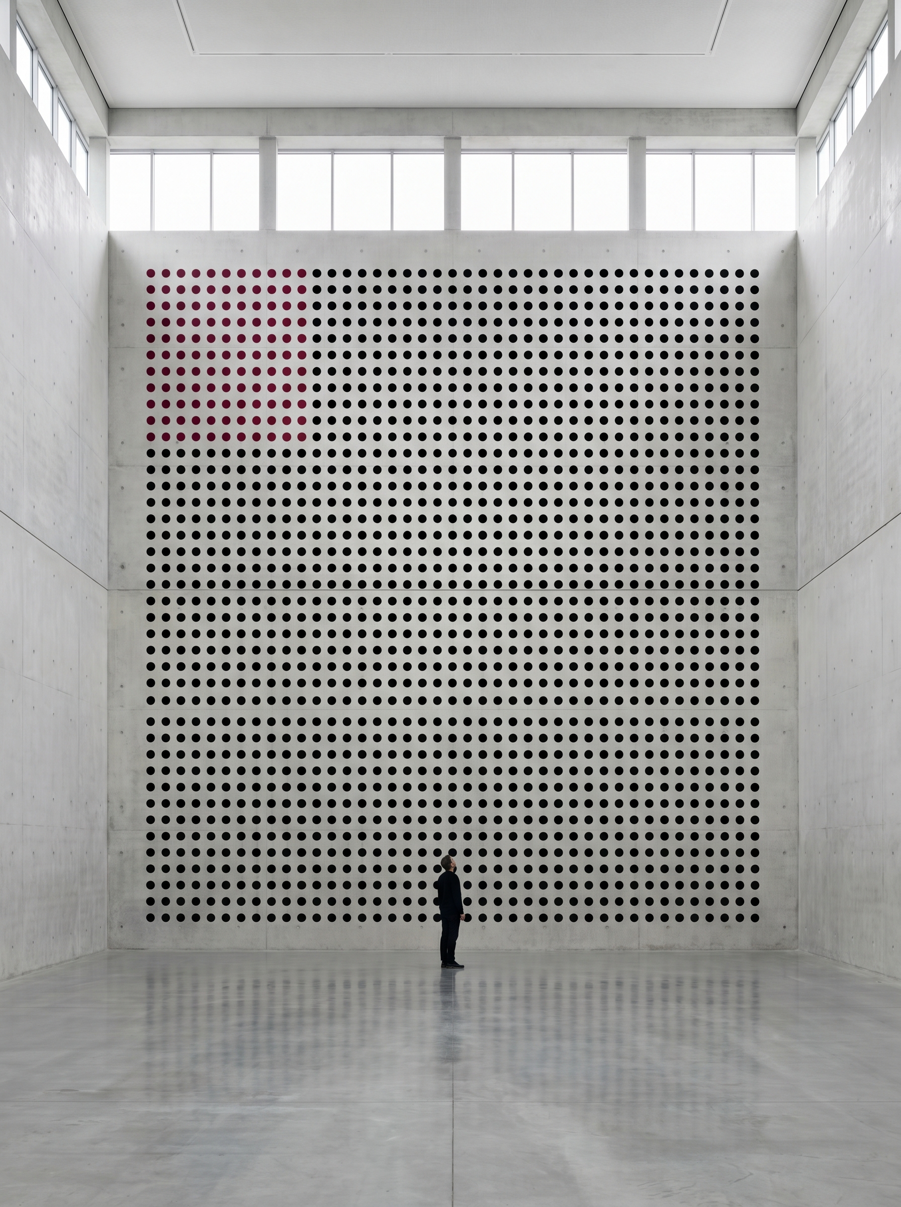 Vast empty room with wall covered in grid of 28000 dots each representing one day of average human life — some red already spent most black remaining, single person small looking up — mortality made visible and countable